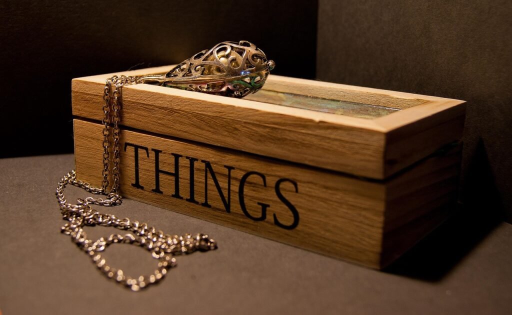 th eimage shows a chain box with a gold neckless . the box is made with wood. chain-box-image